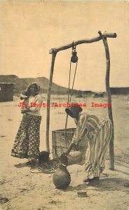 Native American Moqui Indian Woman Filling Water Jugs at a Well in Arizona