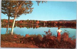 postcard NH - Woman looking out over New Hampshire lake admiring foliage