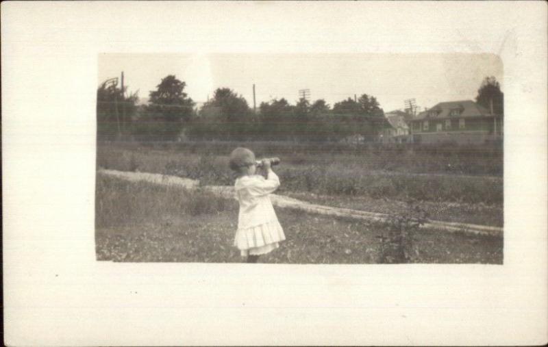 Little Girl Looking Through Binoculars or Spyglass c1910 Real Photo Postcard