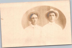 RPPC Two young men in white shirts and hats