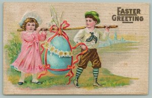 Easter~Victorian Boy n Girl Carry Large Blue Egg By Pole~Pink Dress~Daisies~1911 