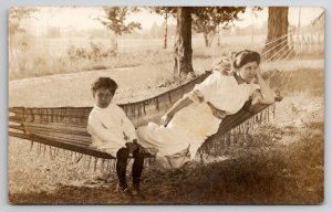 RPPC Woman Relaxing on Hammock Gazing Eyes With Child Postcard E25