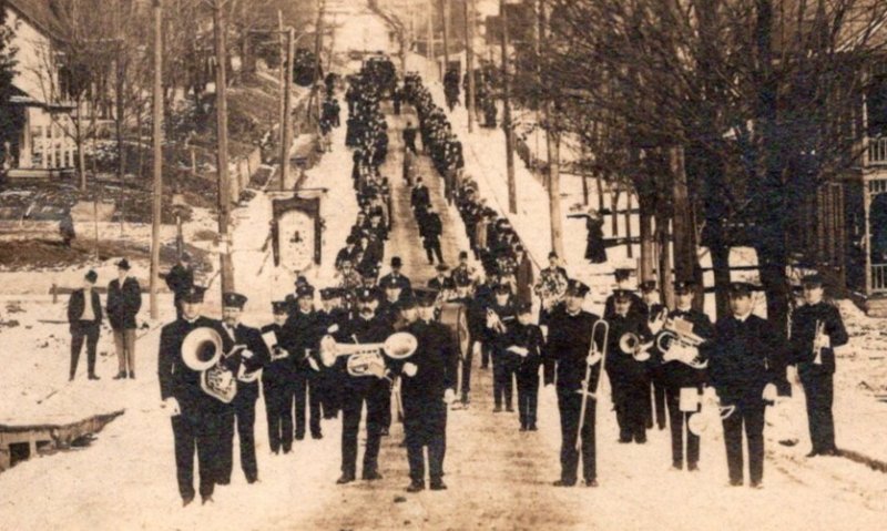 RPPC   Marching Band in Snowy Parade c1910  Postcard