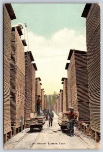 Oregon Lumber Yard~Workers Load Rail Hand Cars~25 Foot Tall Stacks~1910 Postcard