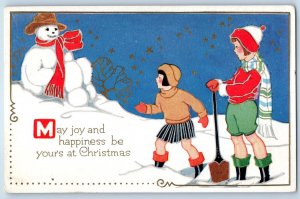 c1910's Christmas Children Build Snowman On Winter Scene Embossed Postcard