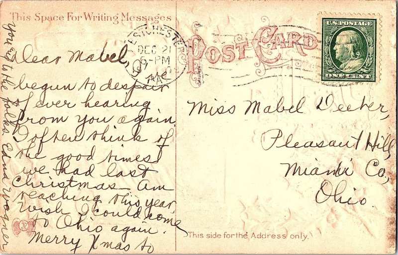 A Peaceful Hearth Embossed Christmas with Holly and Hearth Fire c1910 Postcard