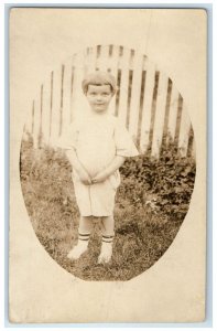 c1910's Cute Little Boy Wearing White Boots Fence Scene RPPC Photo Postcard