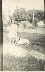 c1910 RPPC Postcard Serious Little Girl on the Lawn w/ her White Dog, Unknown US