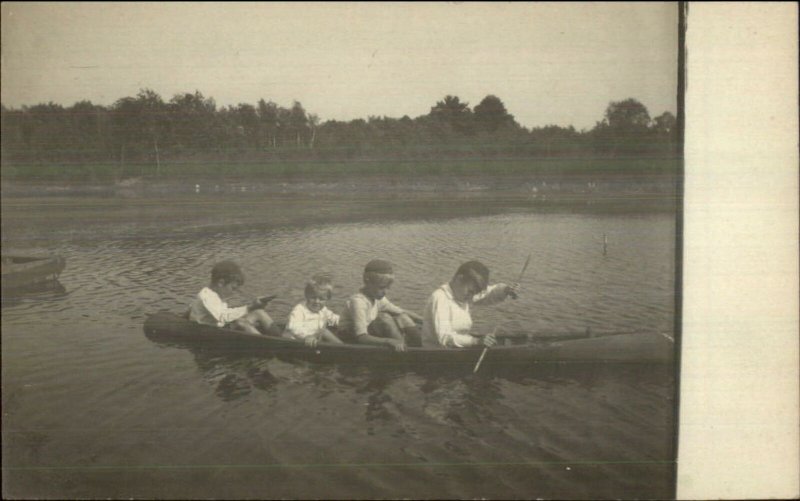 Little Boys in Un usual Tiny Canoe Boat c1910 Amateur Real Photo Postcard