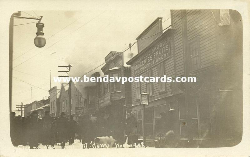 Nome, Alaska, Building on Fire near Carllis Bros. Grocery (1910s) RPPC