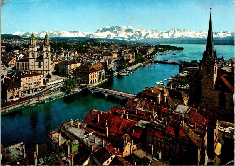 CONTINENTAL SIZE POSTCARD PANORAMIC AERIAL VIEW OF ZURICH AND THE ALPS STAMPS