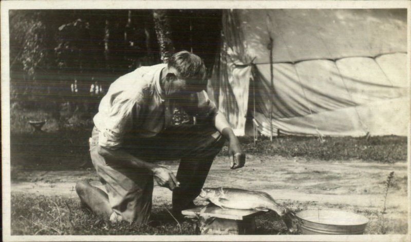 Man Camping Preparing Fish For Cooking c1920 Real Photo Postcard