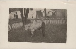 RPPC Postcard Farm Scene Man Walking Cow in Yard