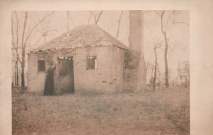 Postcard Woman Entering Old Cabin Grassy Yard Home Simple Living RPPC Real Photo