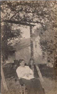 RPPC Old Woman Seated in Yard with Book c1910 Postcard B23