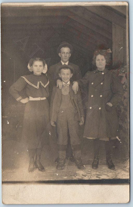 c1910s Family Group Barn RPPC Boy Smiles Newsboy Cap Cute Women Girls Photo A212