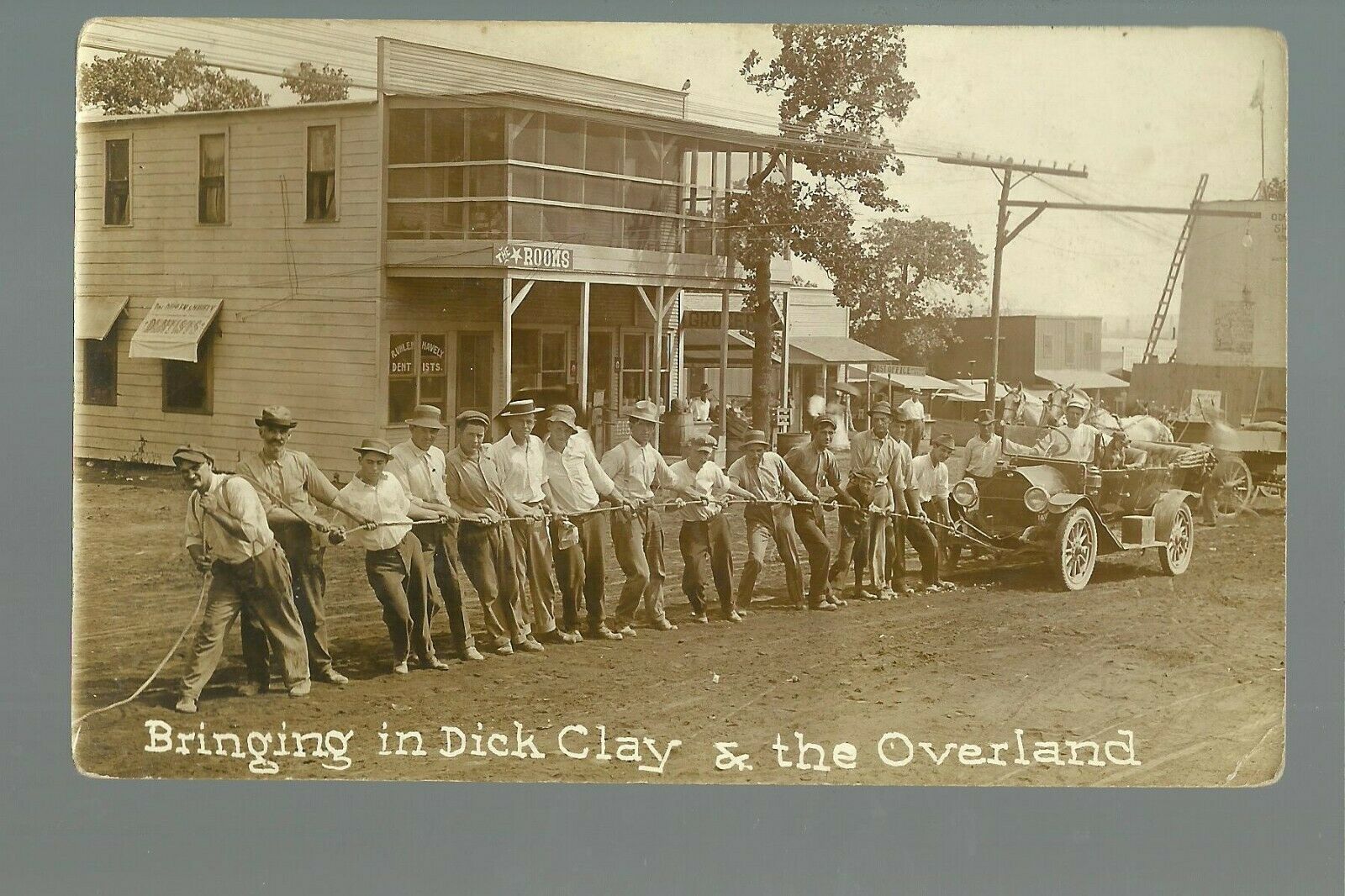 Drumright OKLAHOMA RPPC '10 ADVERTISING Men Towing OVERLAND AUTO