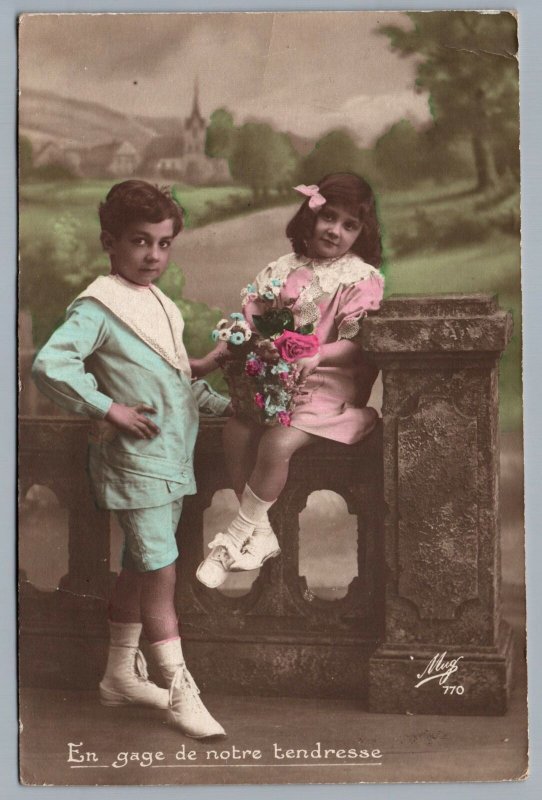 VINTAGE POSTCARD AS A PLEDGE OF OUR LOVE CHILDREN ON LEDGE FLOWERS MAILED 1917