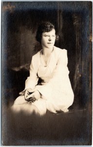 RPPC Woman in white, seated, gazing out window  AZO 1918-1930