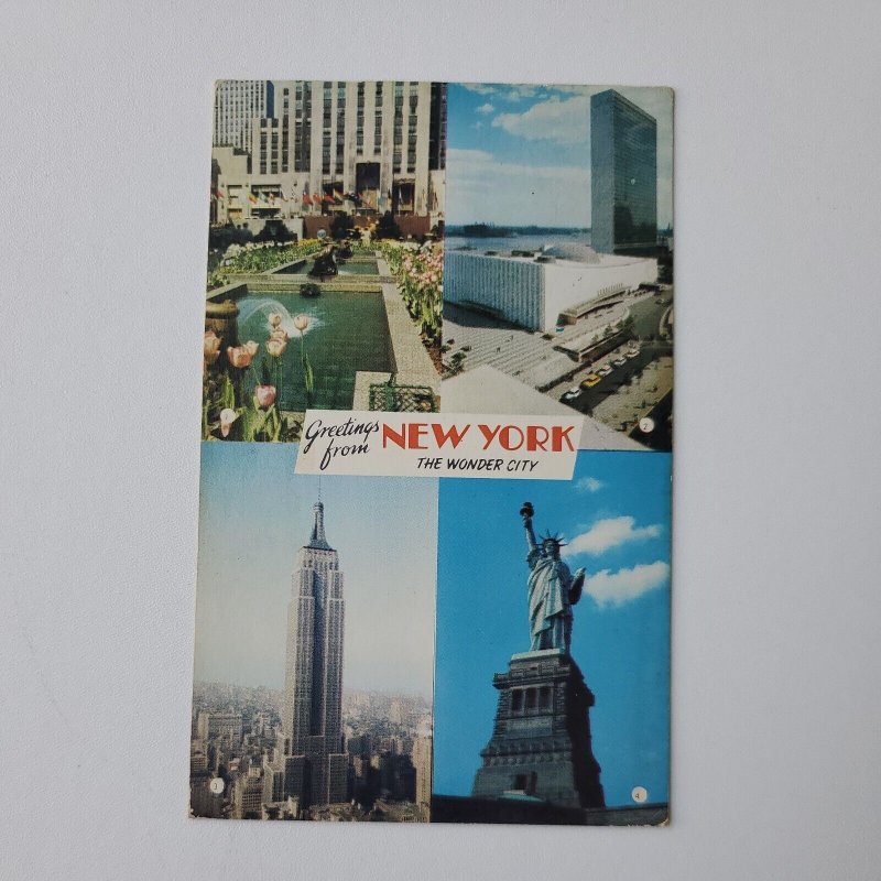 NY Greetings Rockefeller Center UN Empire State Statue of Liberty Postcard