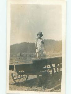 rppc Pre-1918 BOY STANDING ON ANTIQUE STEEL WHEEL FARM WAGON AC7649