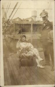 Pretty Woman on Steamship Deck Chair Man in Funny Hat  Real Photo Postcard