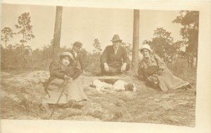 c1910 RPPC; People Lying Around w/ their Hound Dog in a Pine Forest, Unknown US