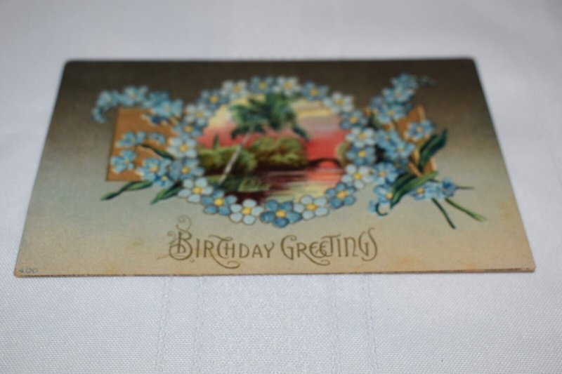 Birthday Greetings Blue Flowers Landscape Scene Embossed Postcard