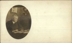 Man at Table Playing Cards Solitaire c1910 Real Photo Postcard