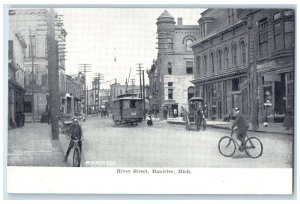c1905 River Street Riding Bicycle Trolley Establishments Manistee MI Postcard