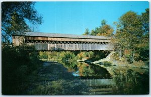 A picturesque setting of an old covered bridge spanning the Saxtons River - VT