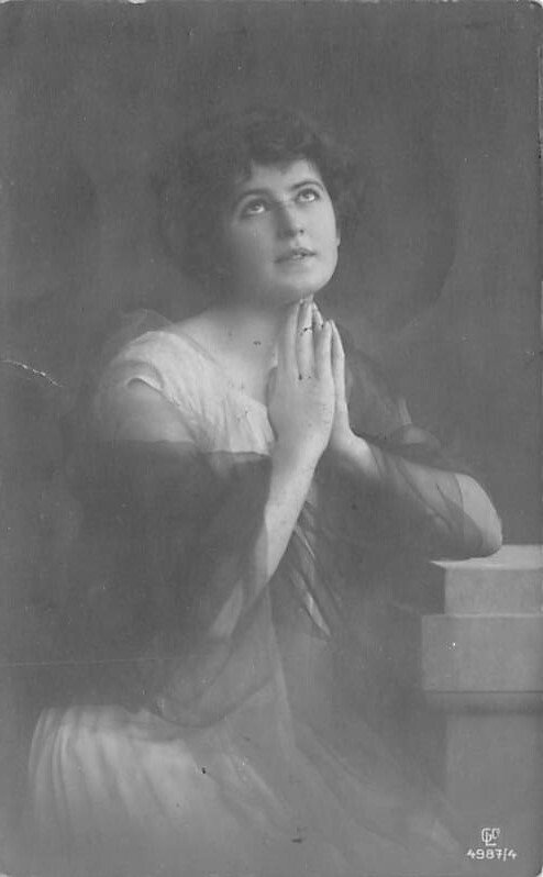 Black and White picture of a woman praying Glamour Woman Writing on Back 