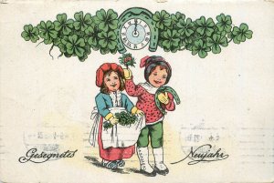 Winter seasonal greetings postcard New Year drawn children luck shamrocks c.1921