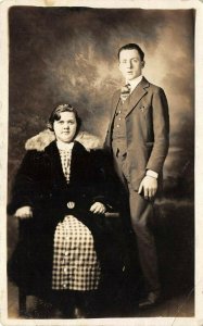 1920s RPPC Real Photo Postcard Couple Man Standing Woman Plaid Dress Coat