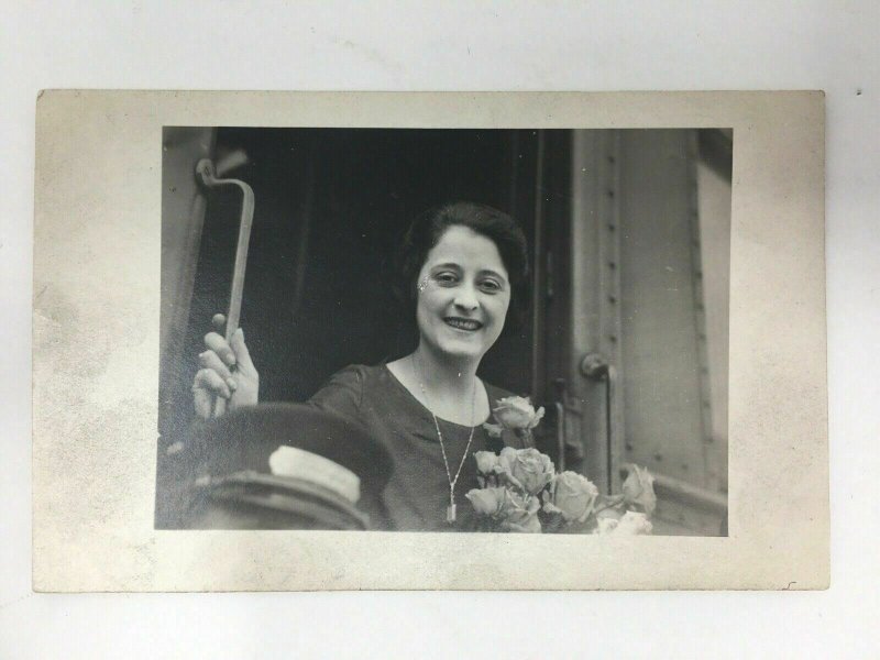 1921 Real Photo Postcard RPPC Woman on Riding Train Flowers Conductor Hat