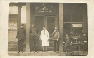 RPPC Postcard Men Stand and Smoke In Front Of Commercial Hotel Ladies Entrance