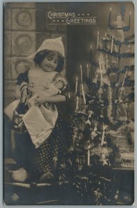 GIRL w/ DOLL UNDER DECORATED CHRISTMAS TREE ANTIQUE REAL PHOTO POSTCARD RPPC