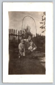 RPPC Father Kneels in Yard w/ Daughter & Son AZO 1904-1918 ANTIQUE Postcard 1311