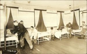 Fire Fighters Dressing Ready to Slide Down Pole Real Photo Postcard c1910