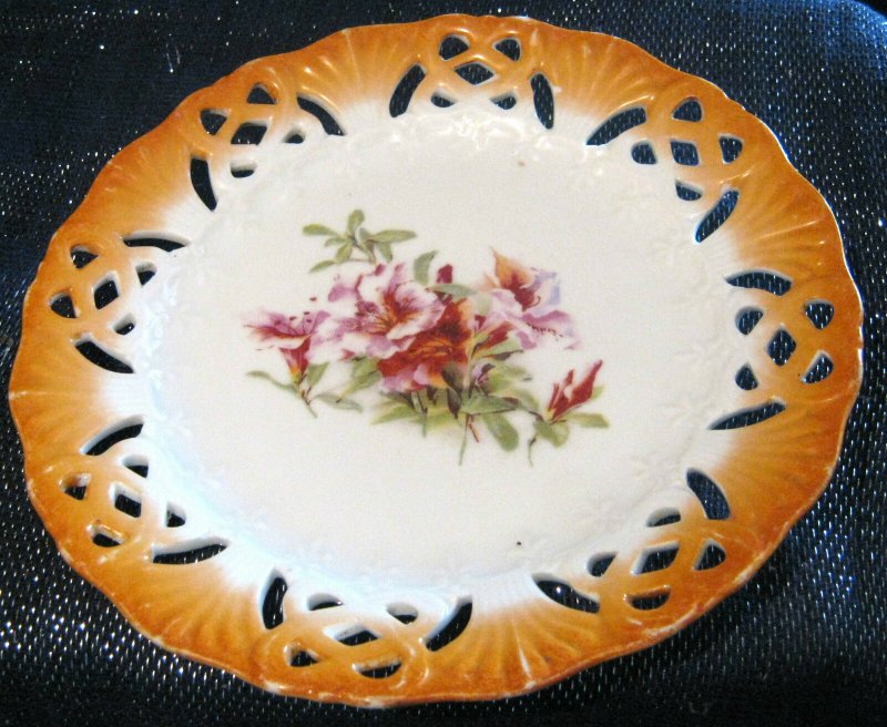 Decorative Plate with very pretty floral centre and pierced rim.  Approx 8.5 ins