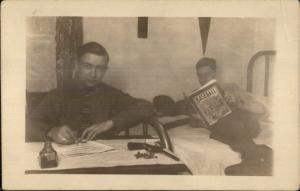 Boys in Bedroom Ink Well Reading Baseball Book Gun on Table c1915 RPPC