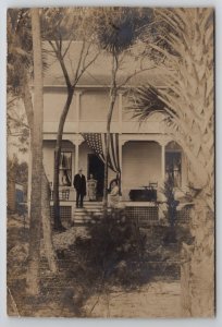 RPPC Family Gathering on Porch Draped American Flag Beach House Postcard L40