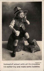 Little Boy Blowing Bubbles Vest Prospector Hat c1910 Real Photo Postcard