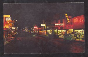 MCALLEN TEXAS DOWNTOWN STREET SCENE AT NIGHT STORES OLD CARS VINTAGE POSTCARD