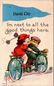 Postcard NE David City - romance couple comic bicycle Next to all the good thing