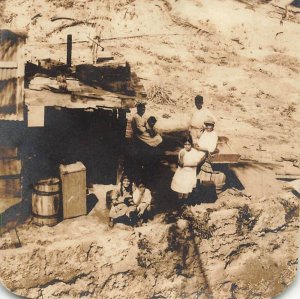 TROPICAL LOCATION-NATIVE FAMILY WITH CHILDREN IN HUT~REAL PHOTO POSTCARD