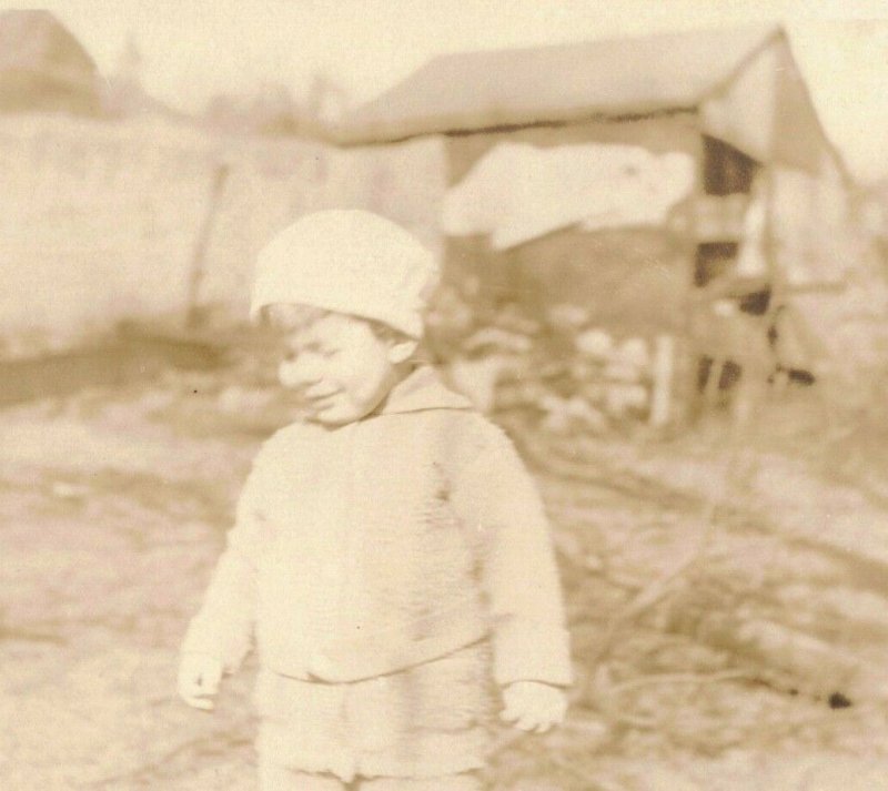 c.1901-07 Little Boy w/ Stocking Hat Wincing by Barn Real Photo 10C1-427 