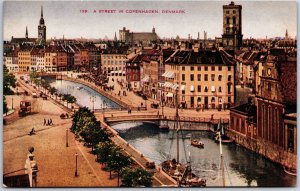 A Street In Copenhagen Denmark Bridge Roadway Buildings Canal Boats Postcard