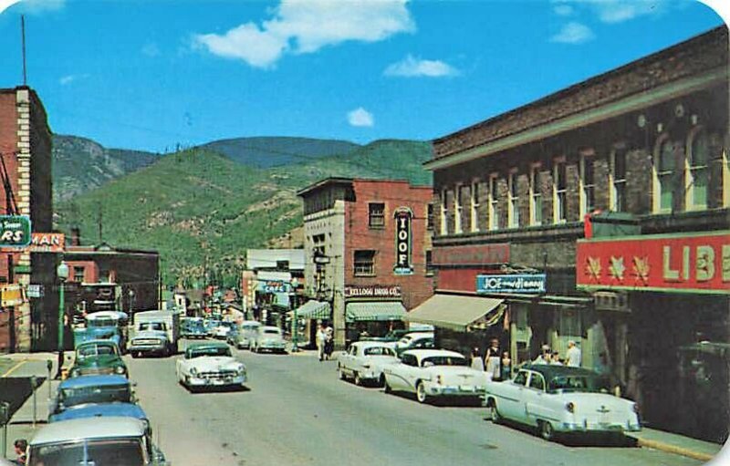 Kellogg ID Street View Storefronts Old Cars Bus & Truck Postcard