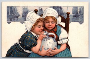 Two Cute Little Girls In Dress Attire Holding White Vase Postcard